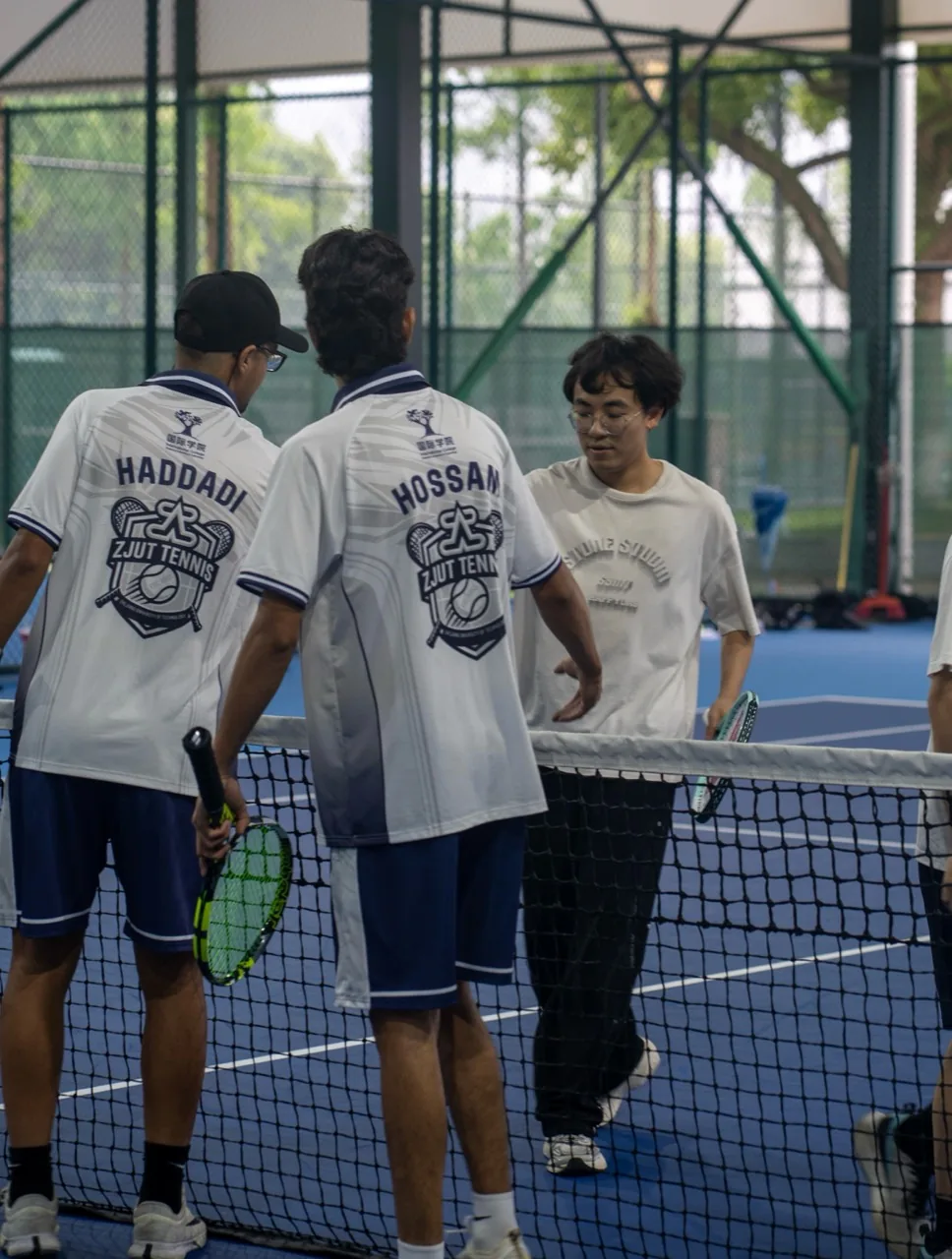 ZJUT tennis players showing the custom names and crest on the backs of their polos
